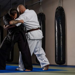 Two karate fighters in kimono showing technical skill